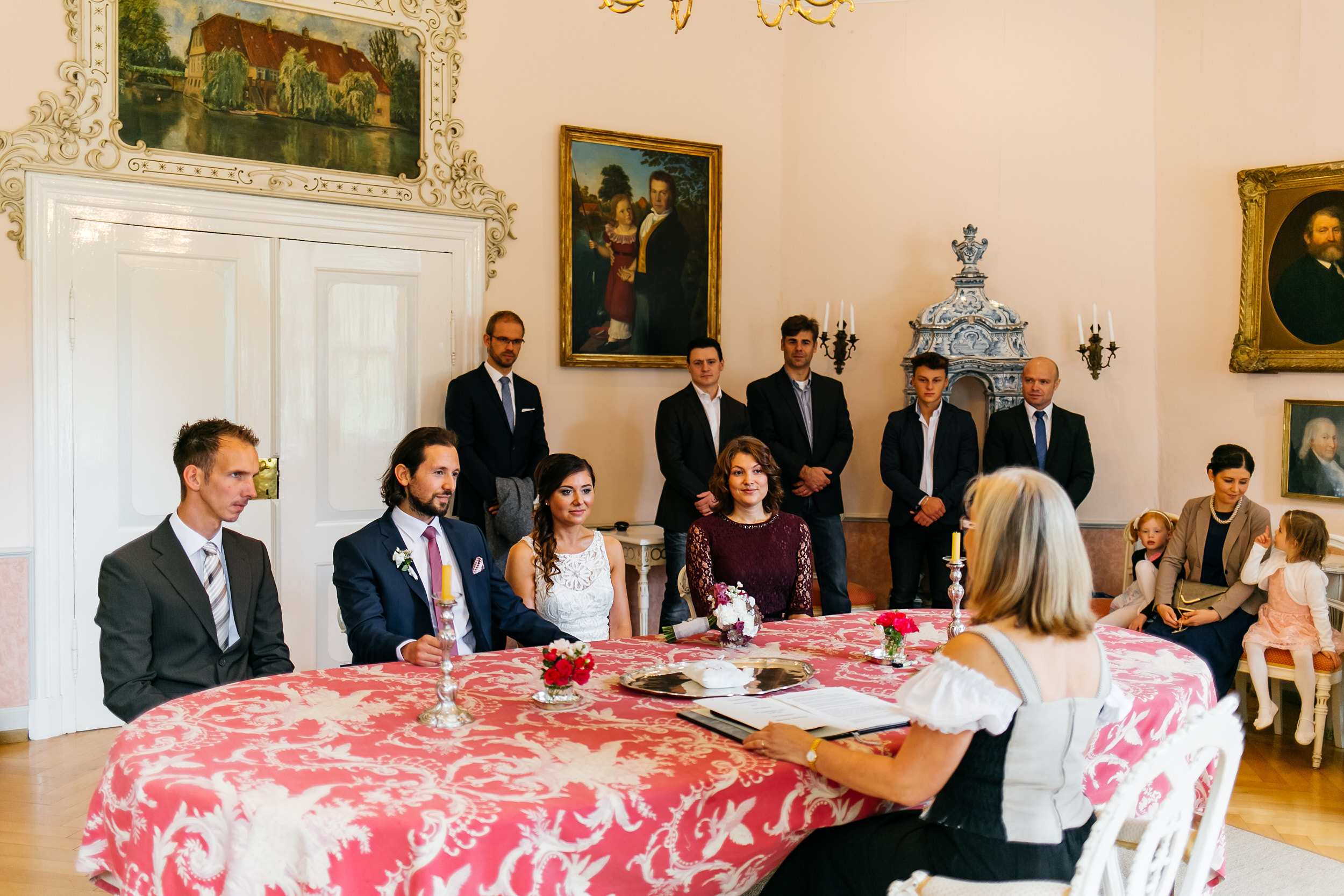 Standesamtliche Trauung auf Gut Eckendorf. Das Brautpaar sitzt mit den Trauzeugen bei der Trauung. Hochzeitsfotograf in Bielefeld.
