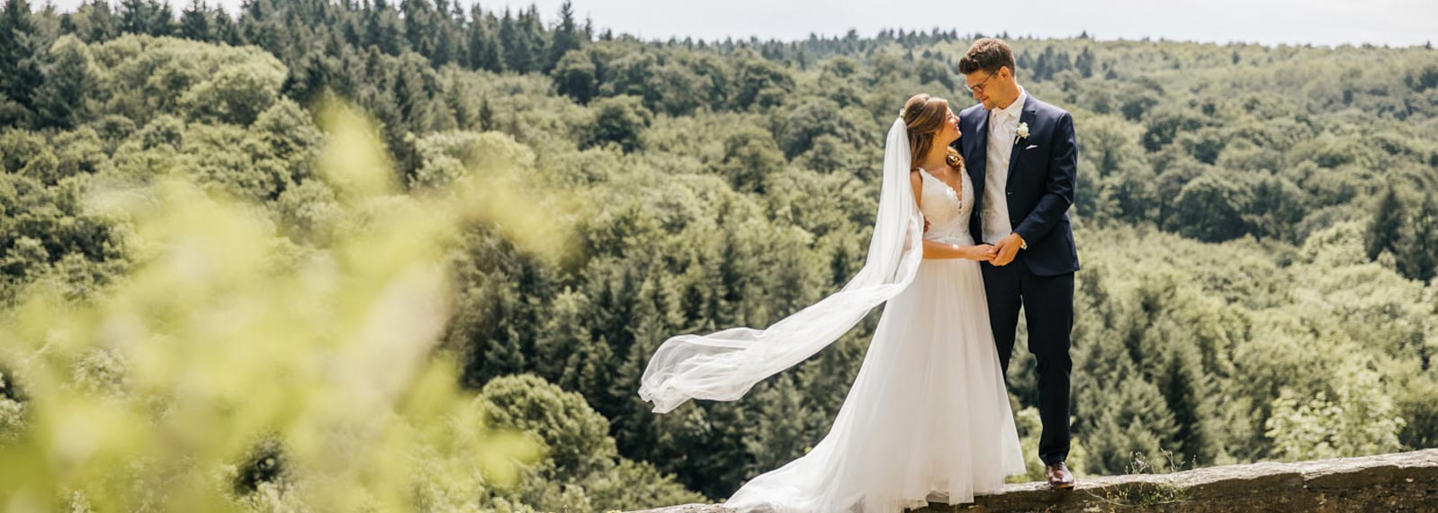 Brautpaarshooting. Brautpaar auf der Mauer.